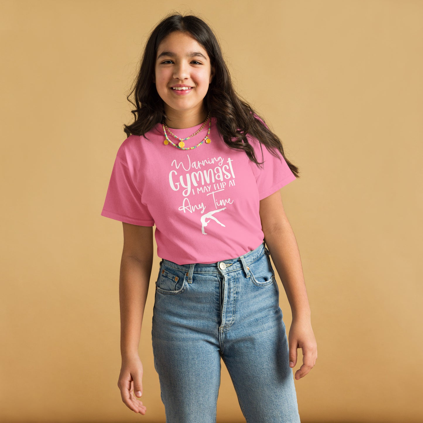 Pink kids gymnast T-shirt with white warning text and gymnast pose graphic on front