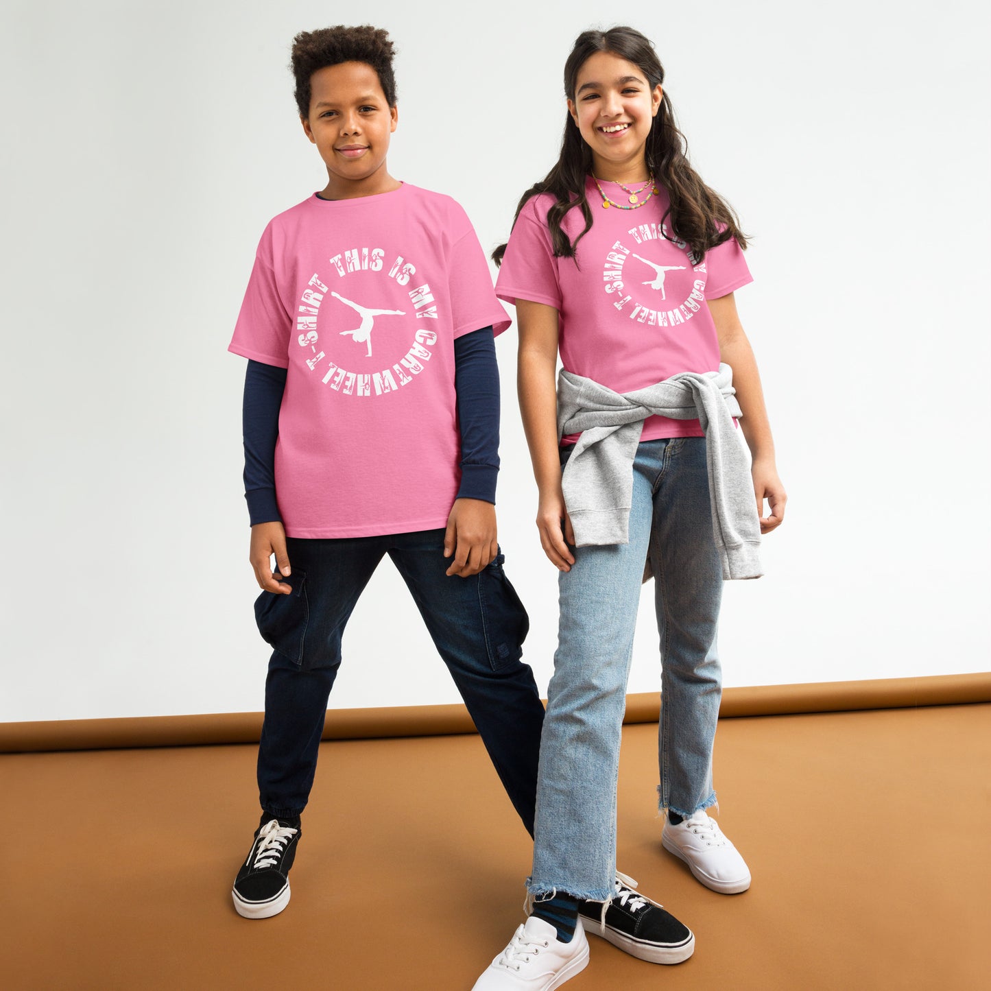 Kids gymnastics T-shirt outfit on two children; pink tee with white gymnast logo