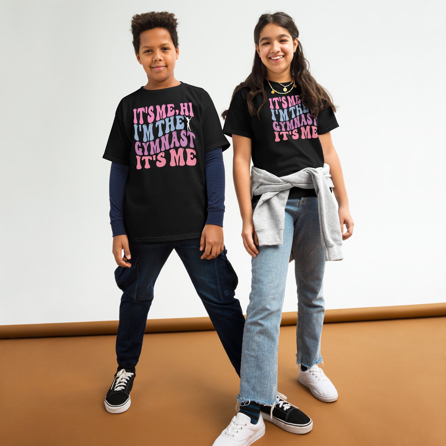 Kids gymnastics T-shirt, black, with pink “It’s Me Hi…Gymnast” text graphic