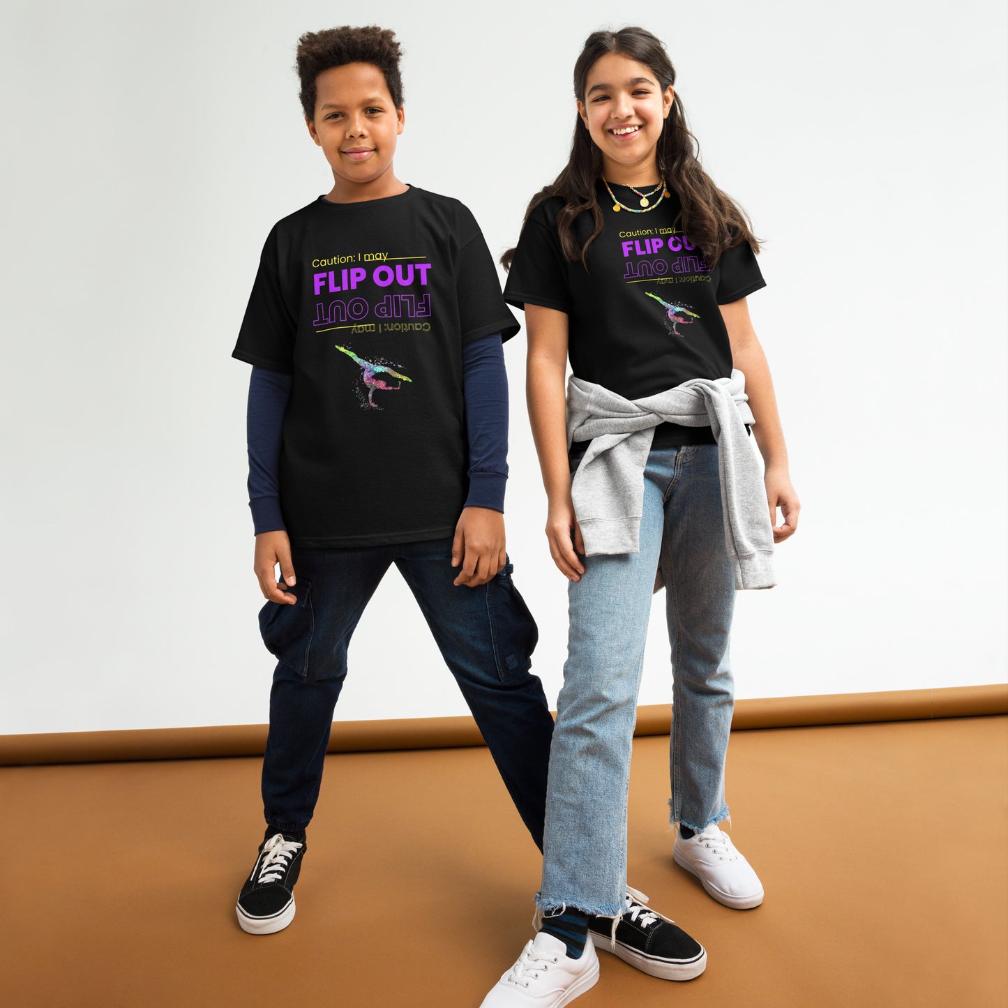 Kids gymnastics t-shirt in black with colorful flip-out dancer graphic, worn by two kids.