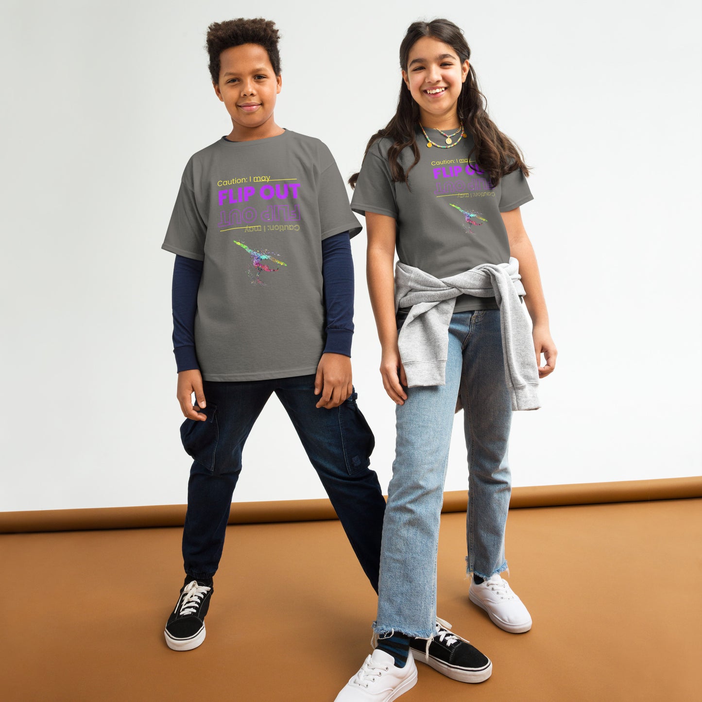 Kids gymnastics T-shirt, charcoal gray with “Flip Out” graphic and small gymnast logo at chest