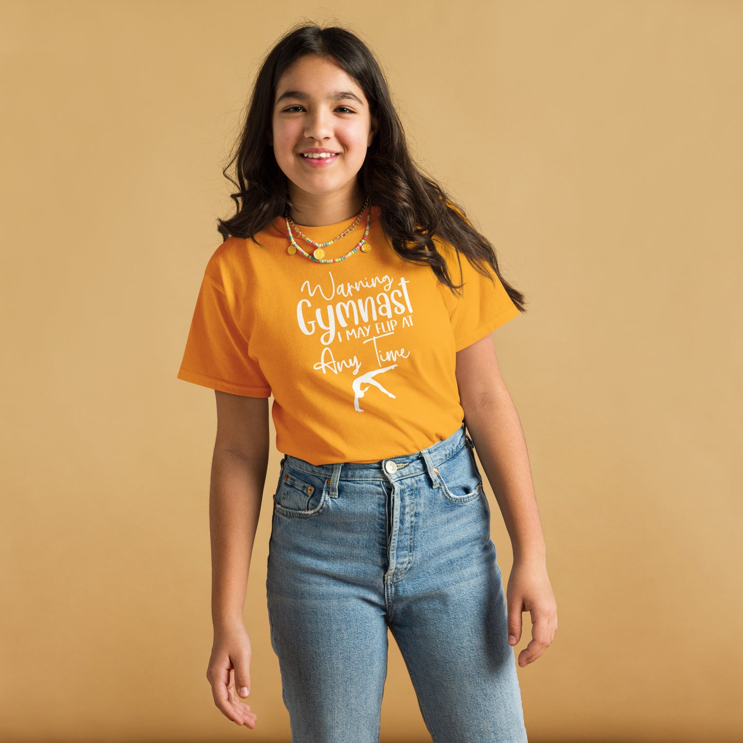 Orange kids gymnast T-shirt with white warning text and gymnast pose graphic on front
