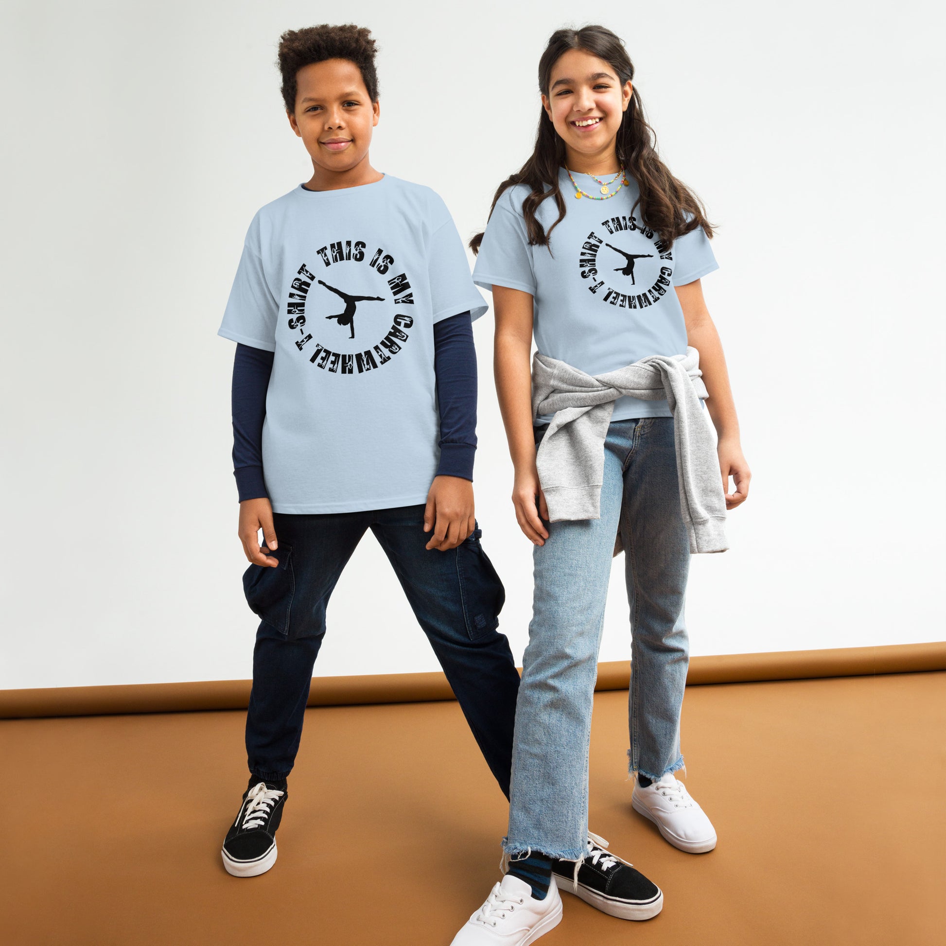 Kids light-blue gymnastics T-shirt, black dancer text graphic, worn by two kids