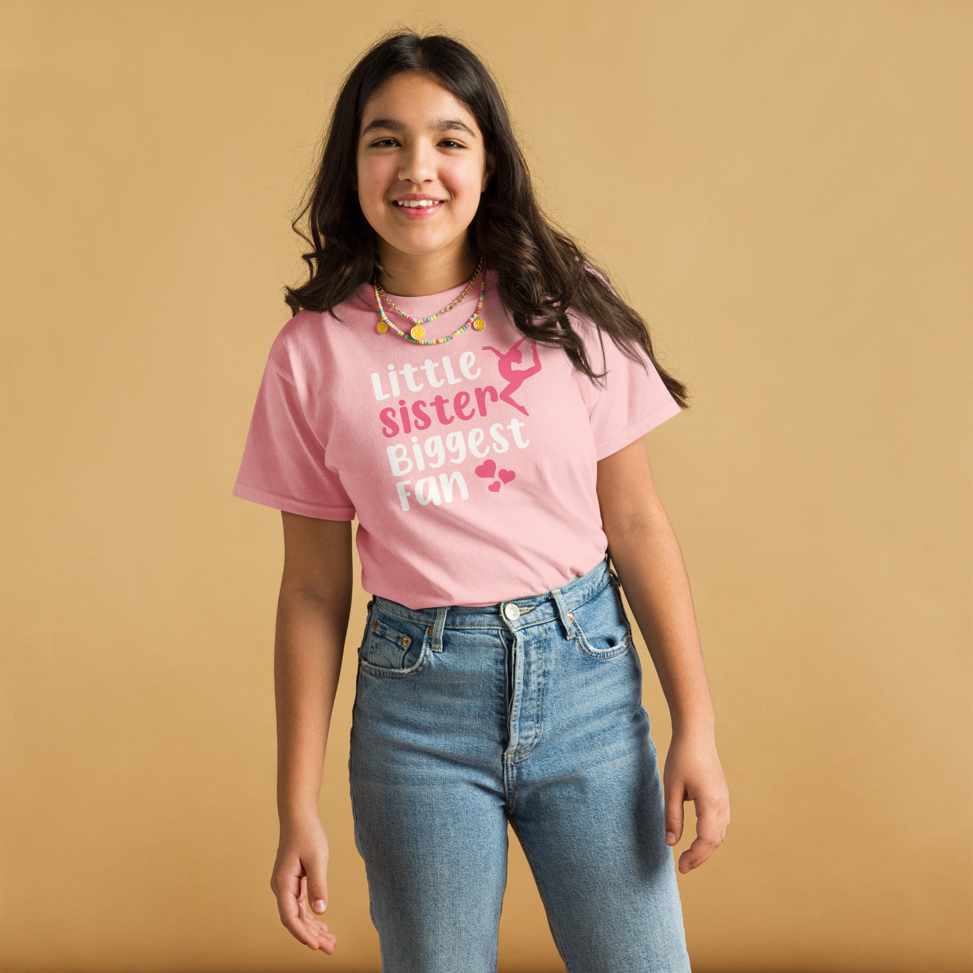 Pink kids gymnastics T-shirt with “Little sister Biggest fan” graphic and pink accents