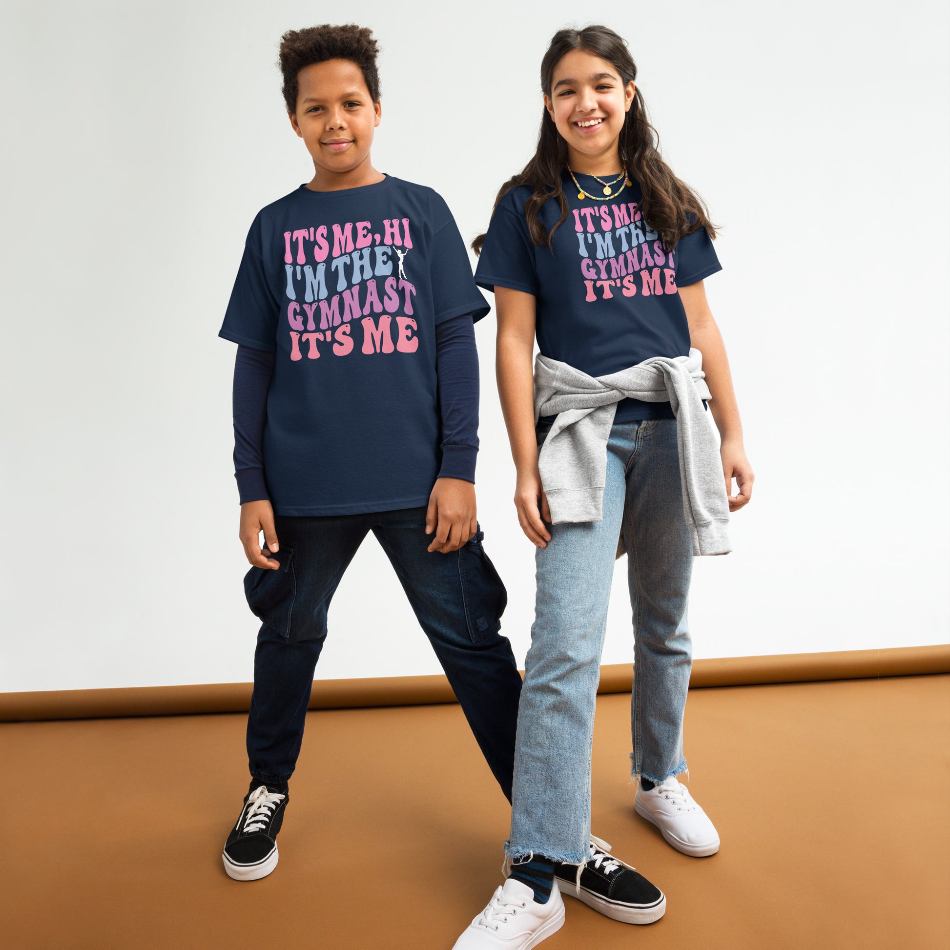 Kids gymnastics T-shirt, dark navy, with pink “It’s Me Hi…Gymnast” text graphic