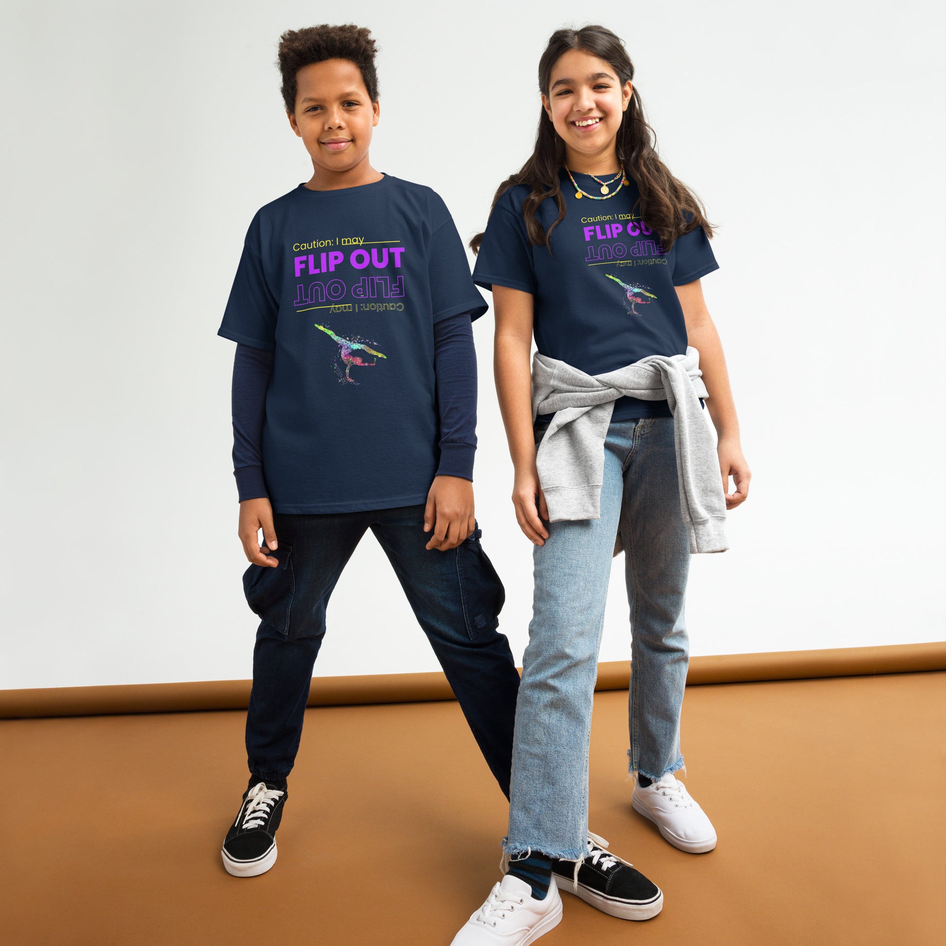Kids gymnastics t-shirt in navy blue with colorful flip-out dancer graphic, worn by two kids.