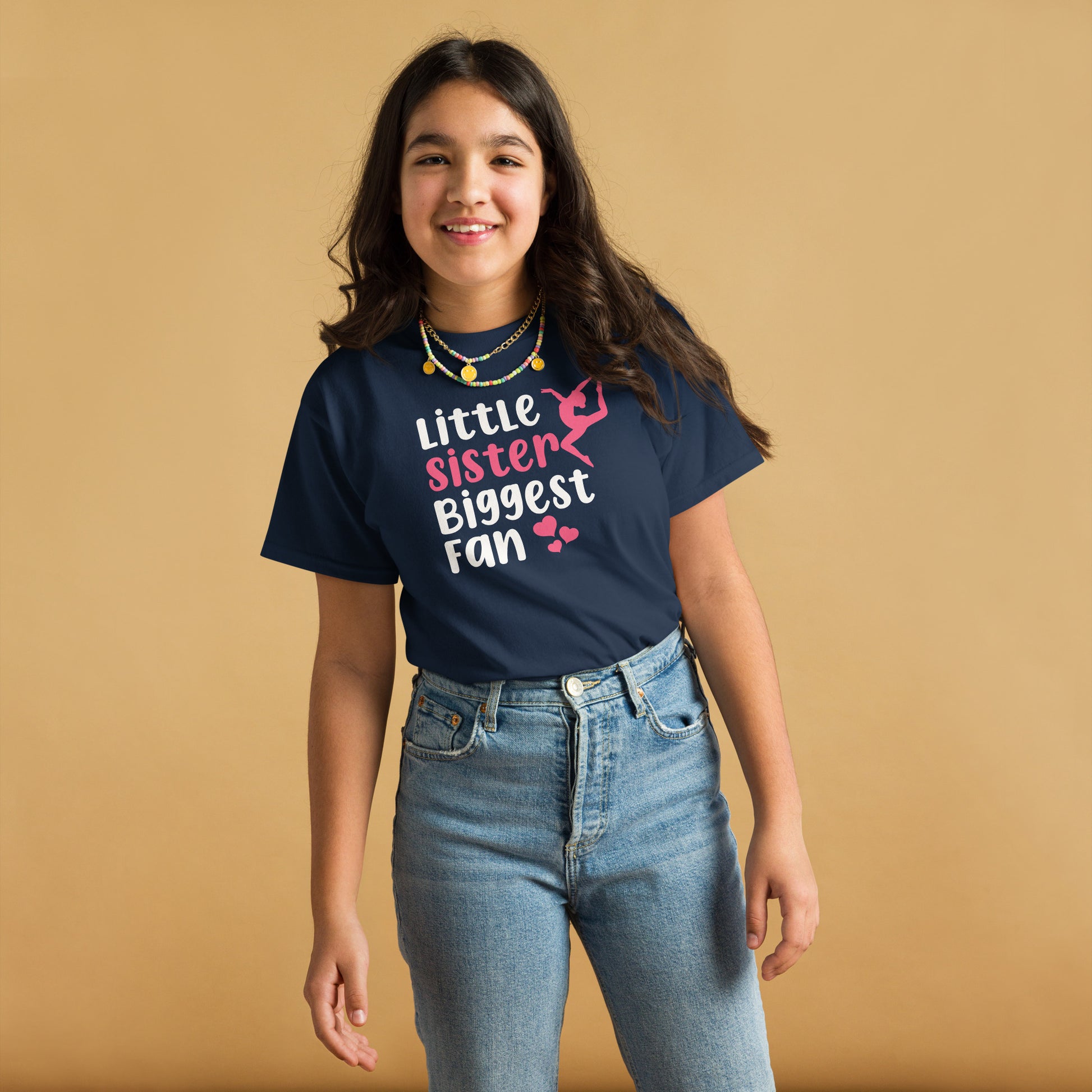 Youth navy blue gymnastics T-shirt with pink gymnast silhouette and “Little Sister” slogan