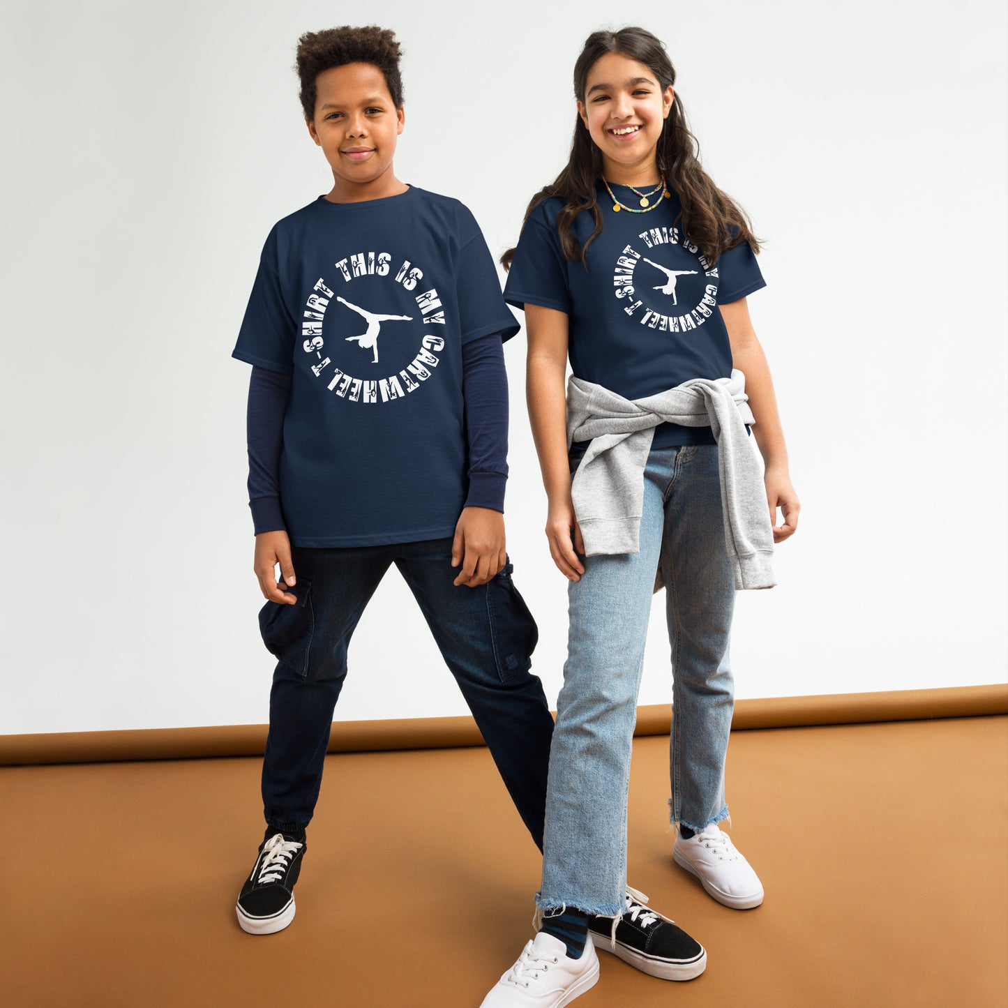 Kids gymnastics T-shirt outfit on two children; navy tee with white gymnast logo