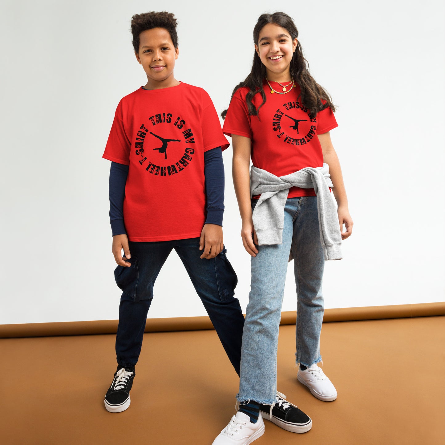Kids red gymnastics T-shirt, black dancer text graphic, worn by two kids