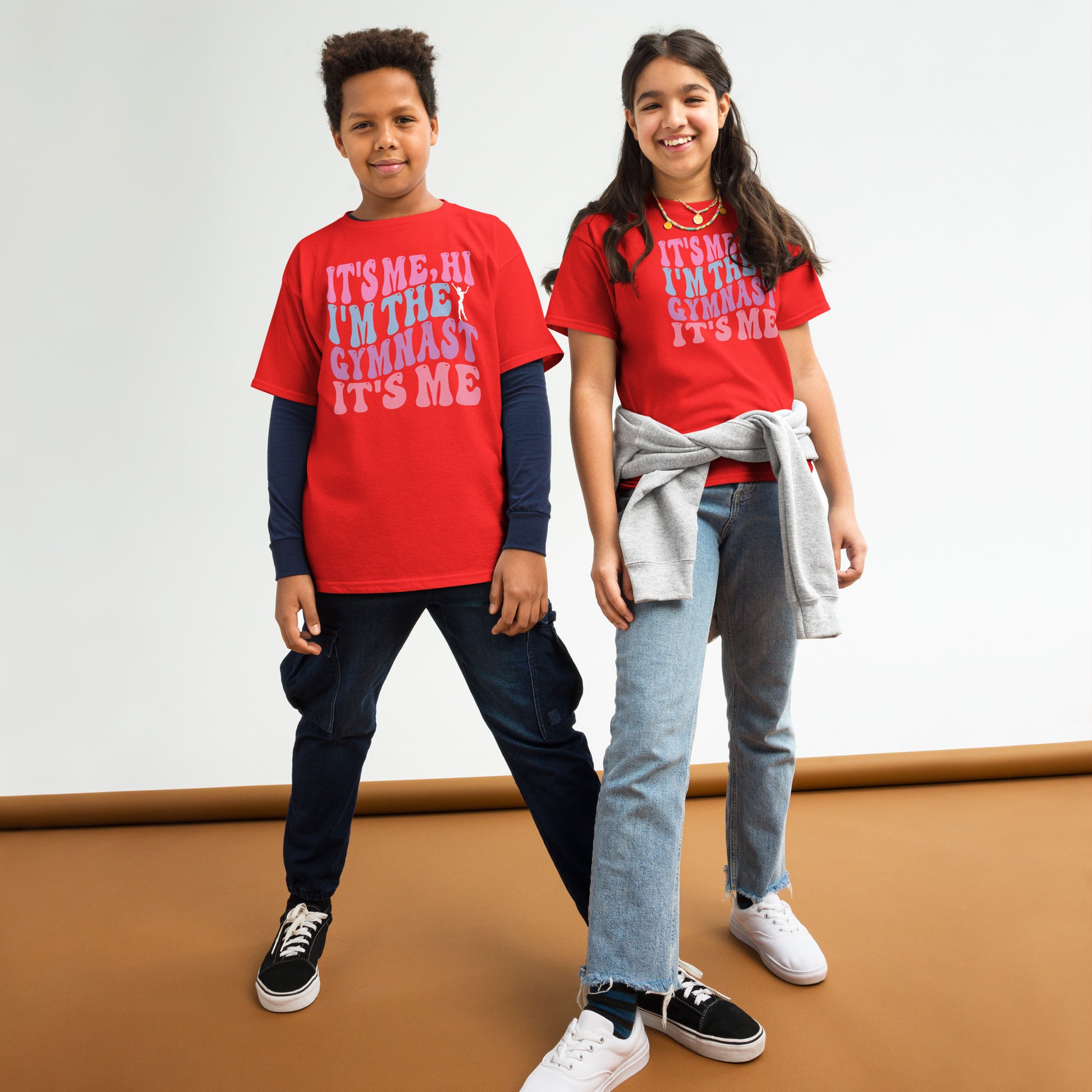 Kids gymnastics T-shirt, red, with pink “It’s Me Hi…Gymnast” text graphic