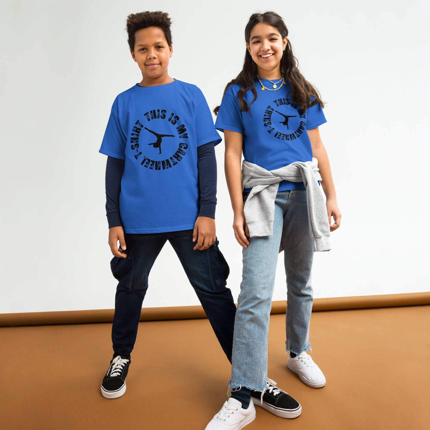 Kids gymnastics T-shirt in royal blue with black gymnast graphic and ring text.