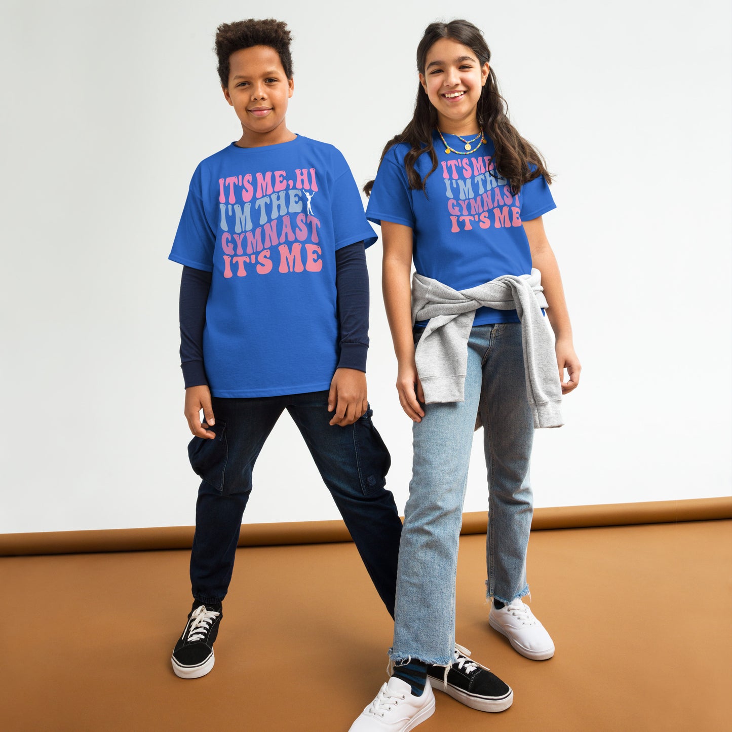 Kids gymnastics T-shirt, royal blue, with pink “It’s Me Hi…Gymnast” text graphic