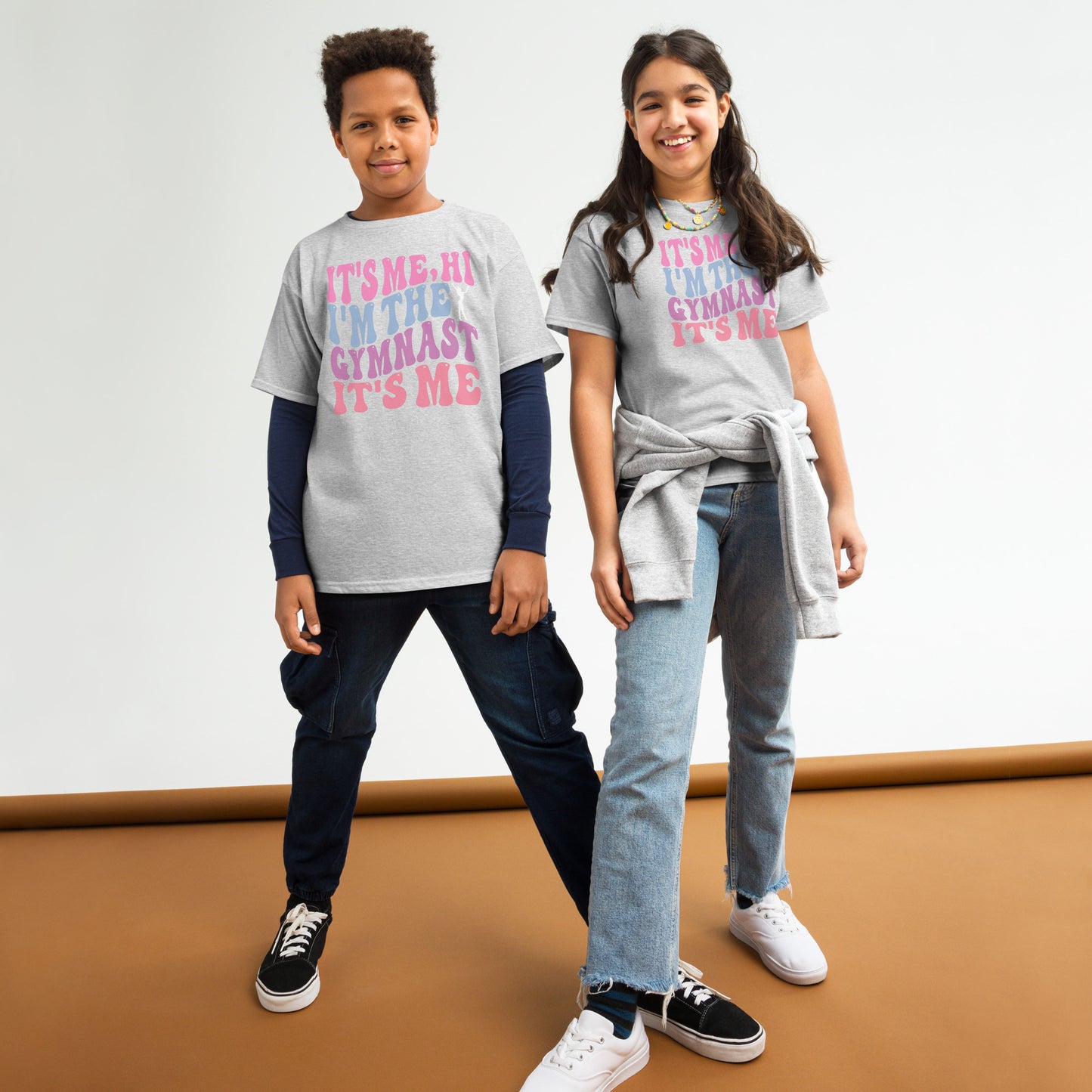Kids gymnastics T-shirt, sport gray, with pink “It’s Me Hi…Gymnast” text graphic