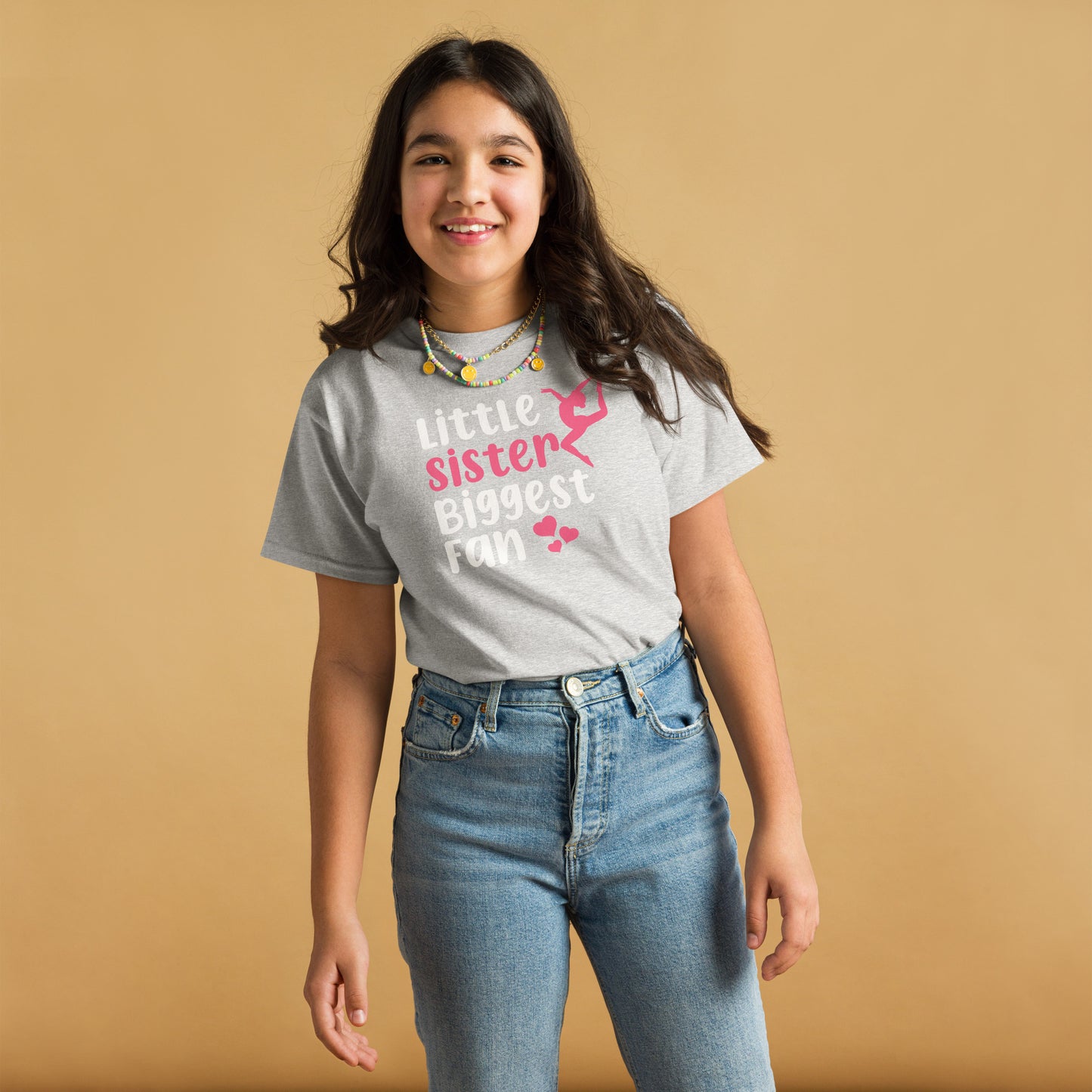 Light gray kids gymnastics T-shirt with “Little sister Biggest fan” graphic and pink accents