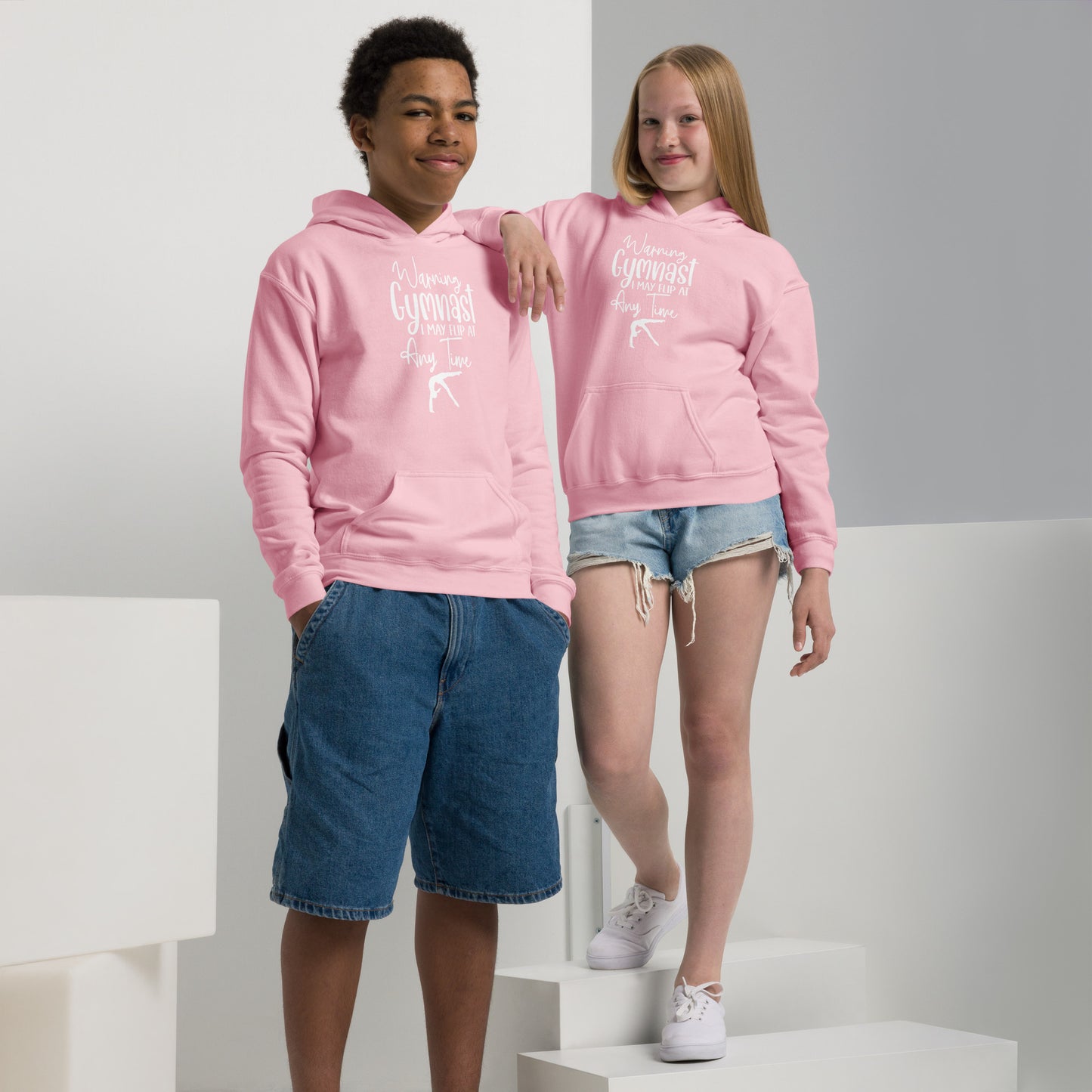 Kids pink hoodies worn by two children, with front graphic, kangaroo pocket, and drawstring hood